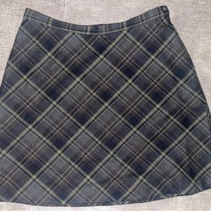 The limited green and black plaid skirt